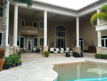 Painting exterior of two story home in Wellington, Florida